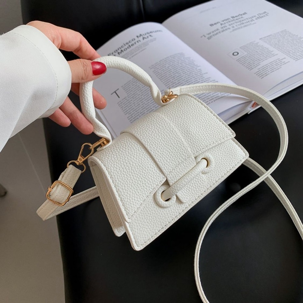 Really cute white small casual purse..fits phone and a couple more small items.